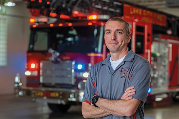 Chief of Lake City Fire Standing in Front of Their Ascendant 107' Heavy-Duty Fire Truck