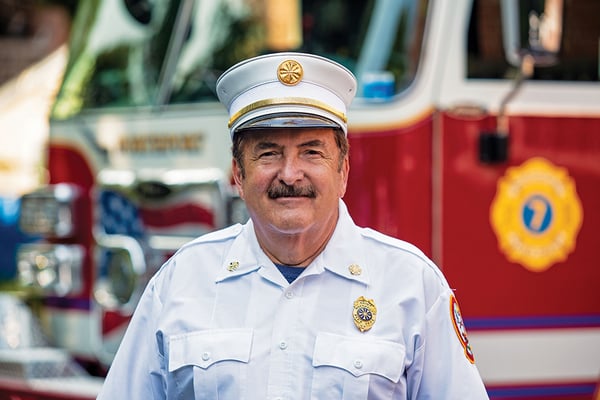 Chief for Northport Fire Department Standing in Front of Their Ascendant 100' Heavy-Duty Aerial Tower Fire Truck