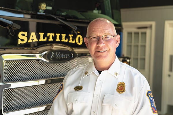 Saltillo Fire Department Fire Chief posed in front of a Pierce fire truck.