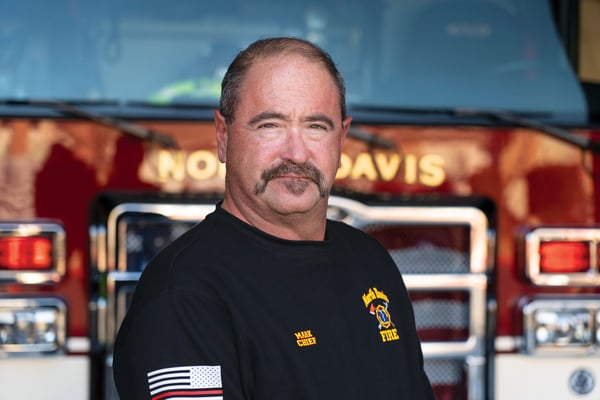 The North Davis Fire District Fire Chief posed in front of a fire truck.