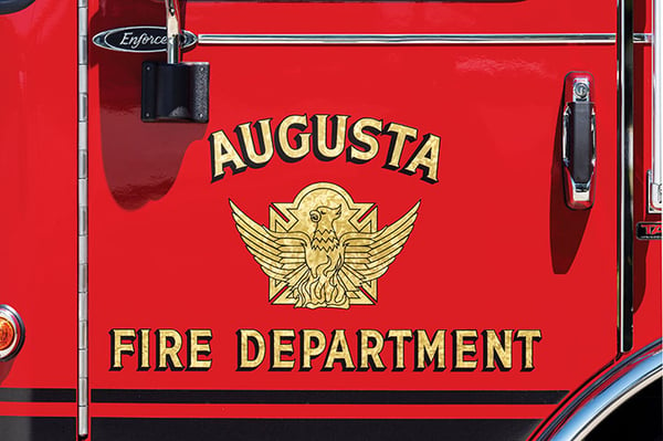 The Augusta Fire Department logo graphic on the drivers door on an Enforcer fire truck.