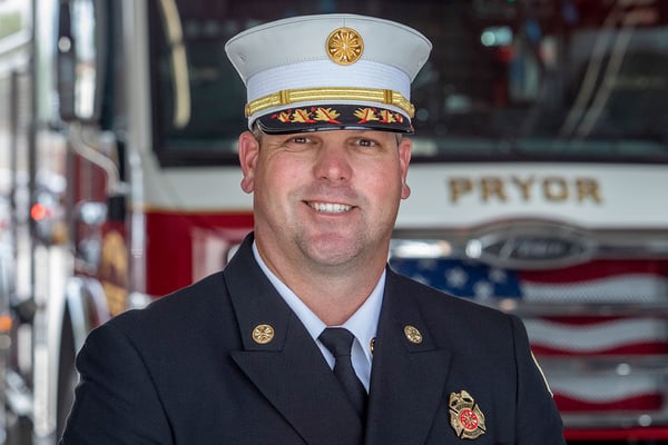 The Pryor Fire Department Fire Chief posed in front of a fire truck.