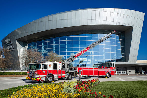 An Enforcer 107 Ascendant Tractor Drawn Aerial with the ladder extended in front of a large building.