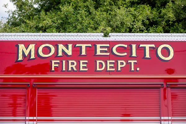The side of a fire truck with graphics for the Montecito Fire Department above the body compartments.
