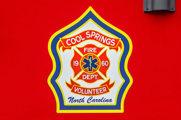 The logo for Cool Springs Volunteer Fire Department in North Carolina on a fire truck door.