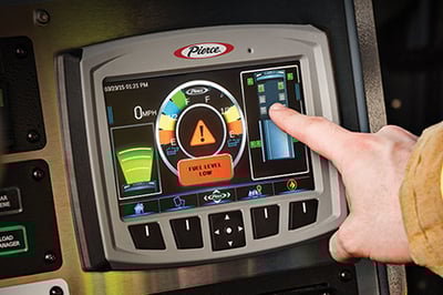A firefighter pressing buttons on the Pierce touchscreen Command Zone™ Electrical System.