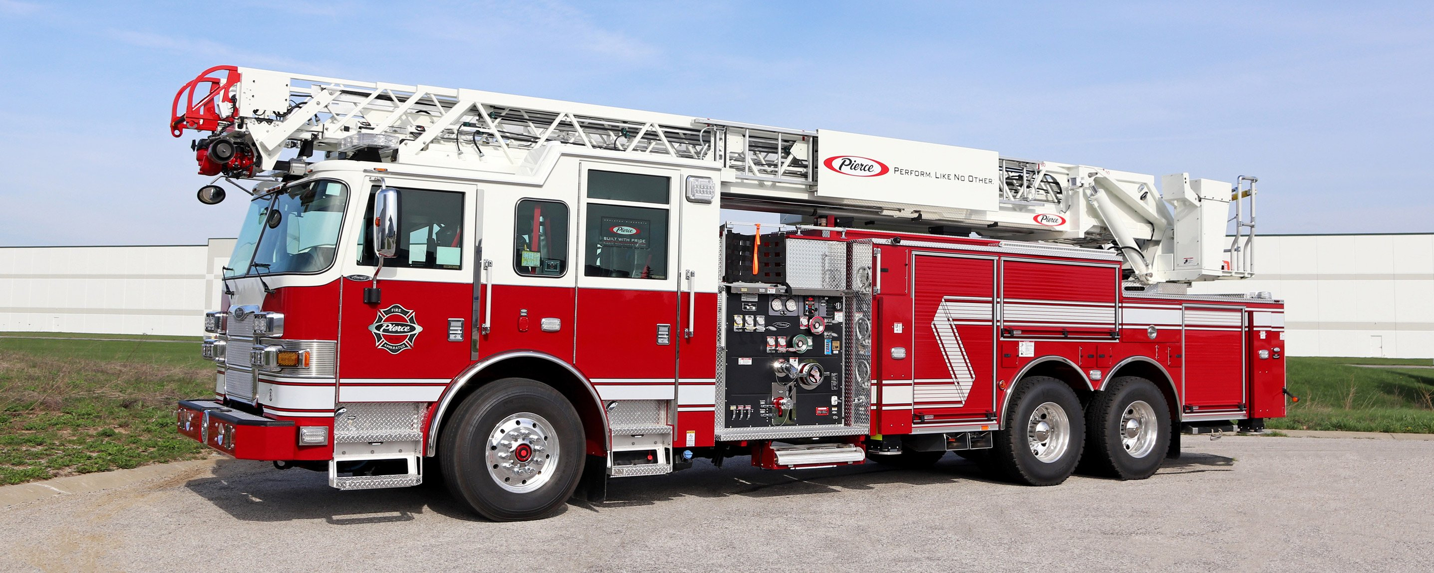A 100' Heavy-Duty Low Profile Steel Aerial Ladder truck parked on an angle, showing the drivers side of the truck.