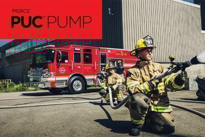 A firefighters in bunker gear sprays a hose in the foreground with other firefighters and a red fire truck in the background. Pierce PUC PUMP is written in black on a red rectangle in the top left corner. 