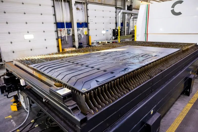 A 30 kW fiber laser cutting sheet metal at a Pierce Manufacturing fabrication facility.