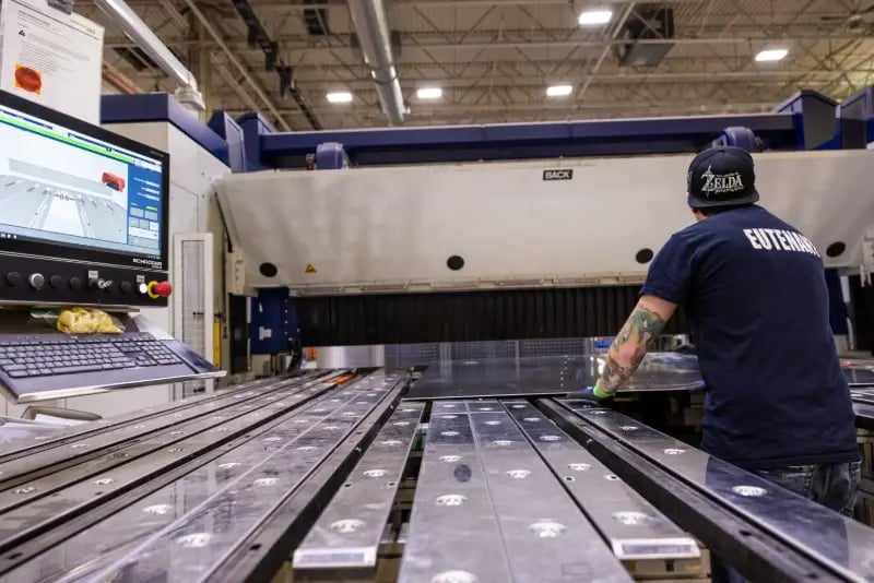 A Pierce Manufacturing operator uses a Schroeder folding machine to fabricate metal sheets.