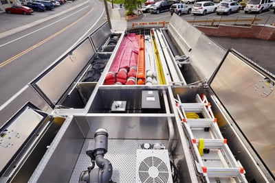 The top of a fire truck shows hatch compartments with tools and equipment. 