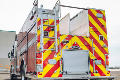 The rear end of a heavy-duty rescue pumper shows the top access ladder, compartment space and hose bed. 