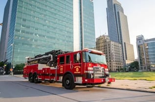 Omaha Fire Department Pierce aerial fire truck in an urban setting with skyscrapers.