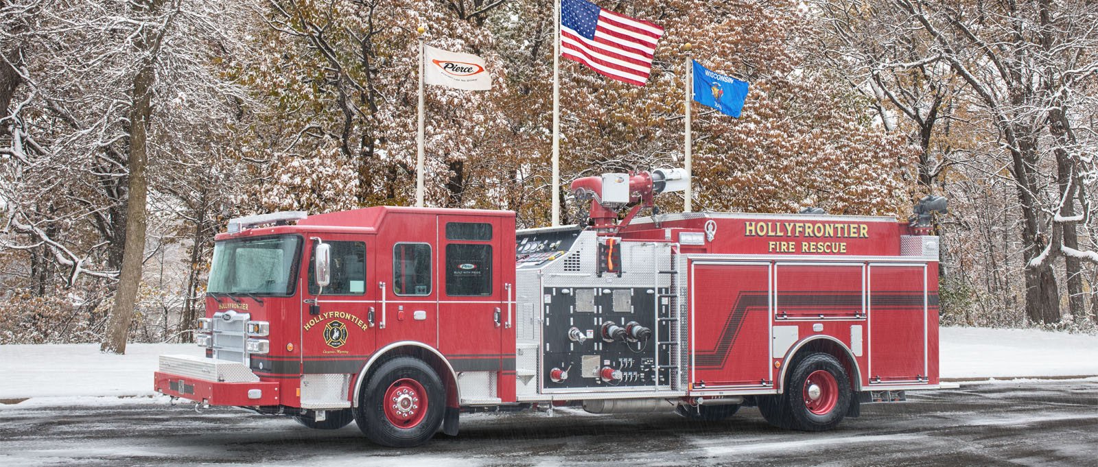 The red HollyFrontier pumper truck is pictured parked in a lot with flags flying in the background. 