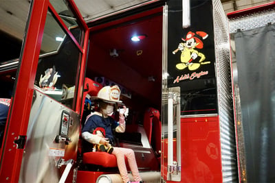 Addi sitting in the cab of Essex Fire Department's new Pierce Arrow XT pumper named "Addi's Engine"