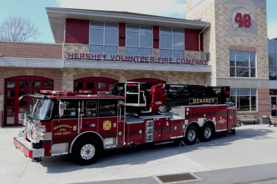 A Hershey Volunteer Fire Department truck sits on the apron in front of their fire house.