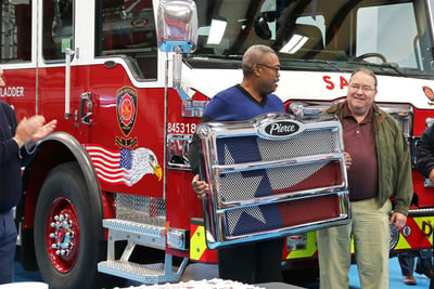 A Pierce customer receives a custom Pierce grille with a flag painted on it. 