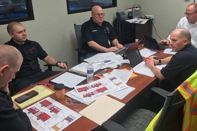 At a fire truck pre-construction visit, Pierce team members sit down with fire department representatives to review the bid specifications and proposed configuration to finalize the fire truck order.
