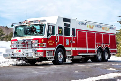 Cold weather safety is an important aspect of fire truck manufacturing, and this Pierce truck on a snow-covered forest road is ready for operation. 