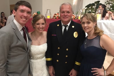 Spartan Fire and Emergency Apparatus sales representative, Alan Axson, poses for a photo with Tara, her husband Mitchell, and mother, Melody.