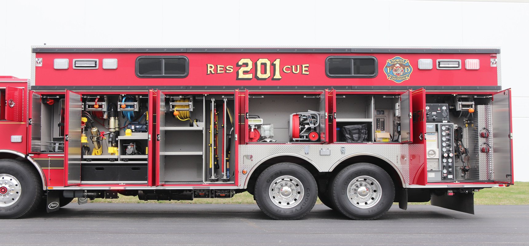 Pierce Non-walk-in rescue side view showing all compartments opened and tools, gear, and equipment are in place.