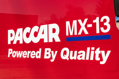 The PACCAR MX-13 logo and “Powered By Quality” on a red Pierce fire truck body. 