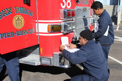 Pierce service technicians gather around a Pierce fire apparatus to study the concerns and find a solution.