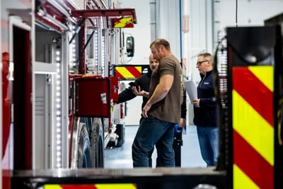 Fire department representatives and technicians inspect a fire truck at the factory.