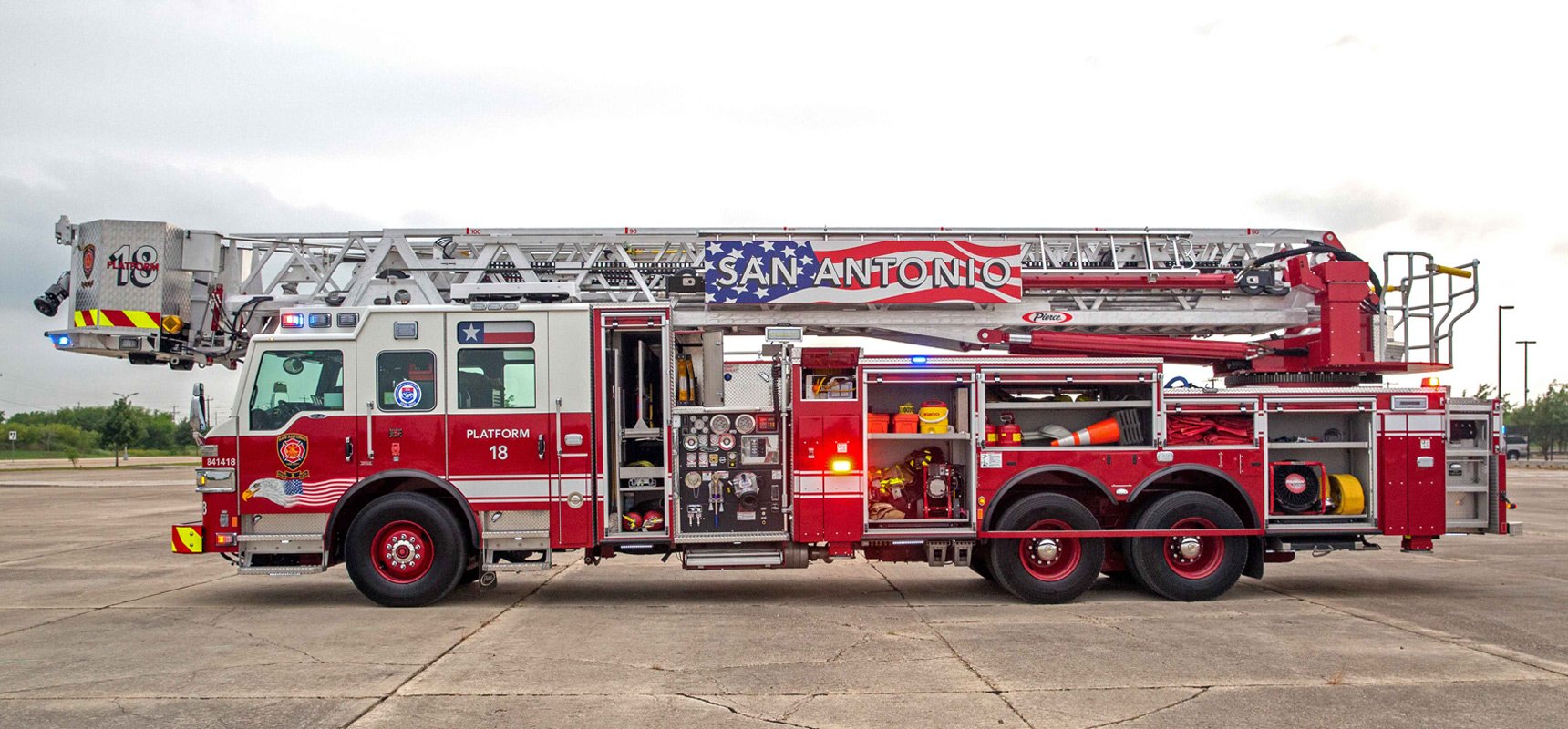 A fire truck featuring versatile transverse compartments and storage over the pump.