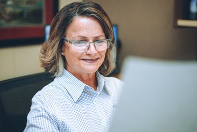 A Pierce engineer works at her computer, finalizing fire truck components and system requirements in the detailed engineering phase of a fire truck order. 