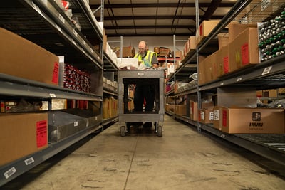 Pierce employee in spare parts warehouse gathering parts to fulfill an order.