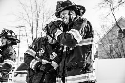 firefighters-outdoorsFirefighters in a candid moment horsing around in turnout gear outdoors.