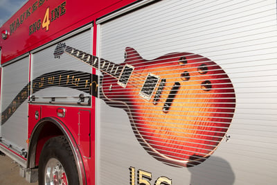 A close up shot of the detailed Les Paul-inspired guitar graphic on a Waukesha fire department fire apparatus. 