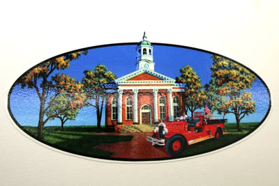 Hand painted fire truck graphic of an old schoolhouse and vintage car in a country setting. 