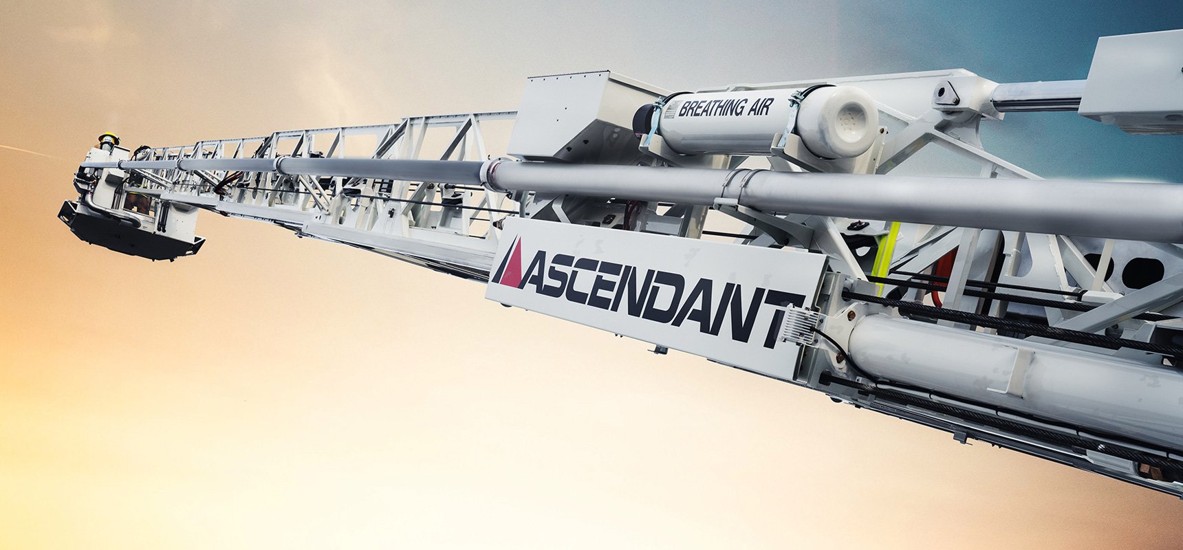 An ascendant aerial device is fully-extended in the air, showing the heavy-duty 100K psi high-strength steel design.