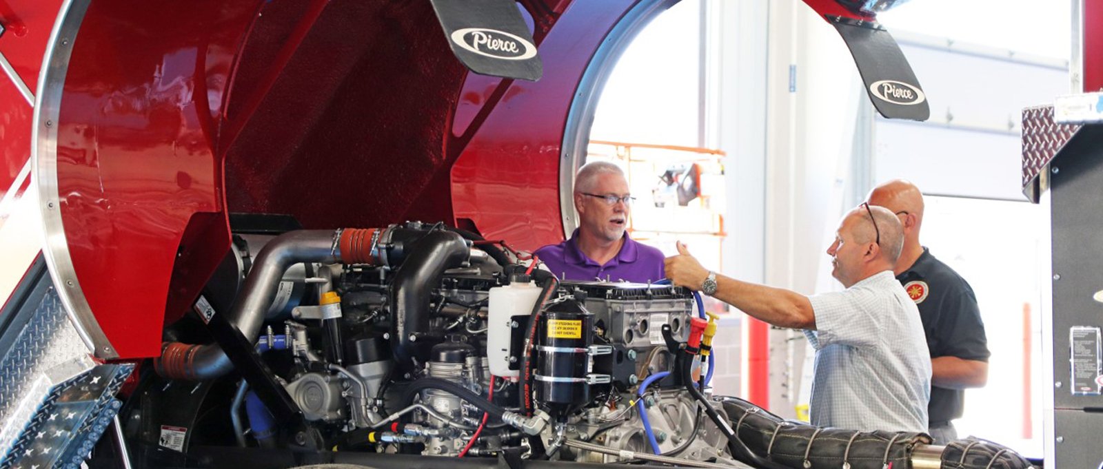 Pierce customers inspecting their final pierce fire apparatus and being shown the benefits of the truck as well as preventive maintenance tips.