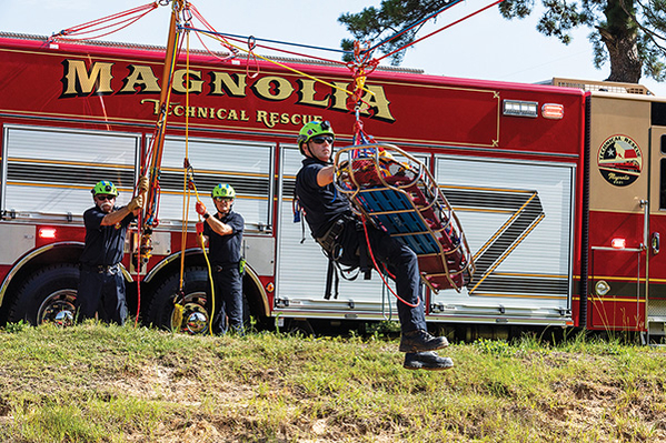 Firefighter deploying from Rescue Fire Truck