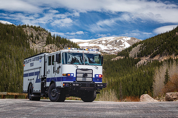 Blacked out pumper fire truck driving in mountain ranges
