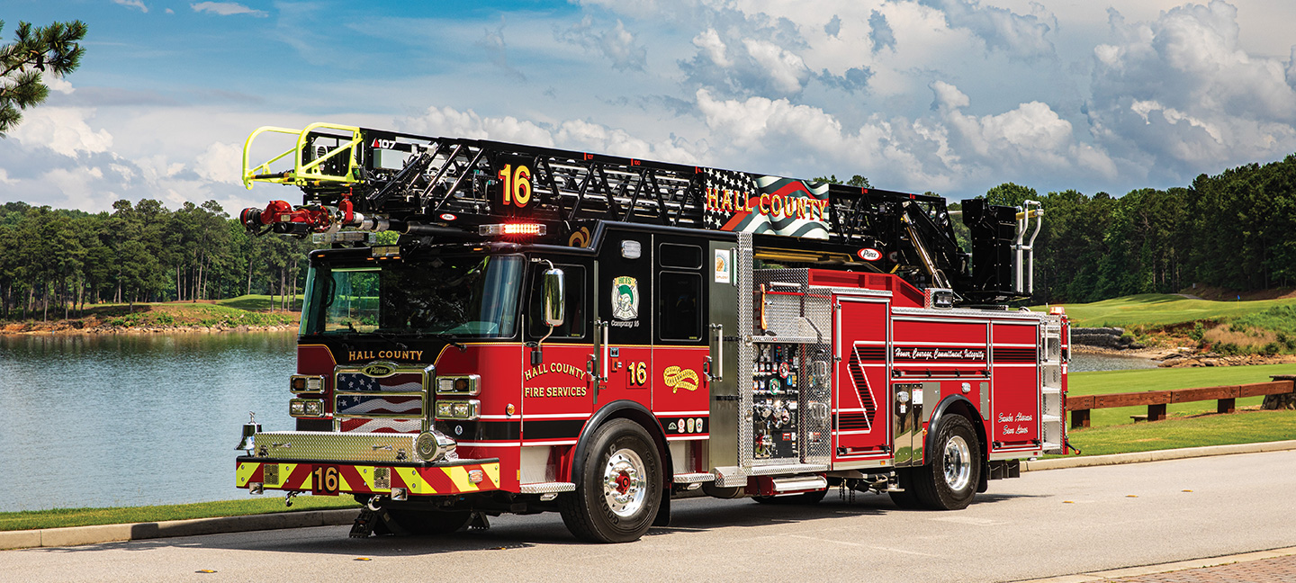 Pierce ladder fire truck parked in sun in front of lake in Georgia