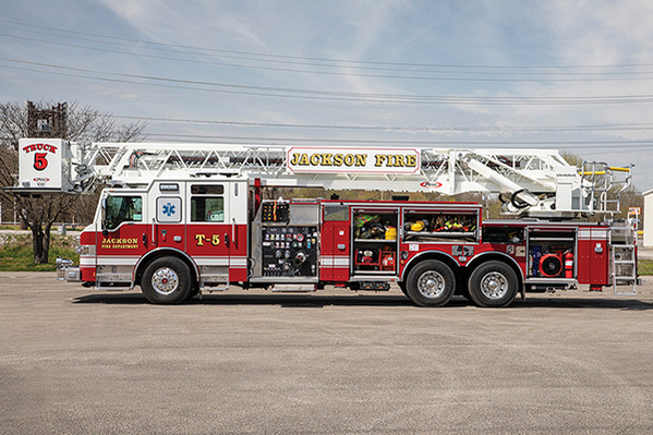 Aerial Platform Fire Truck parked with compartment doors opened to show equipment loaded on drivers side