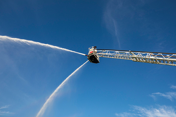 100' MidMount Aerial Platform Spraying Water Off Dual Deck Guns