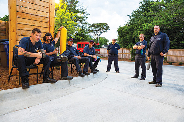 Firefighters gathered in front of fire station