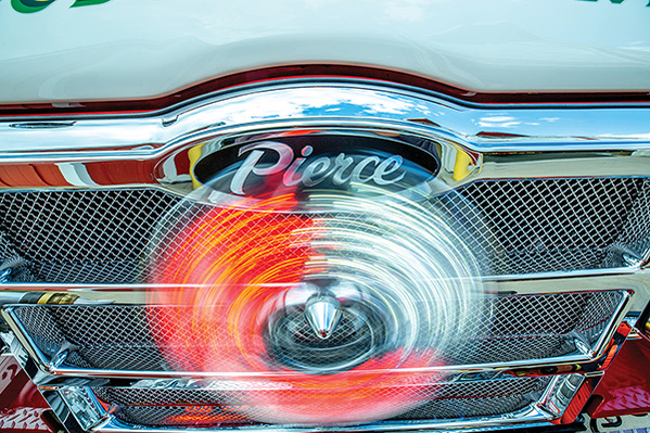 Fire Truck Roto-Ray light lit up on front grille of pumper fire truck