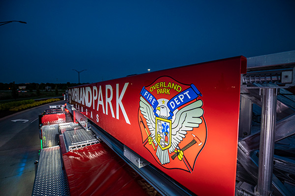 Aerial ladder fire truck lit up at night