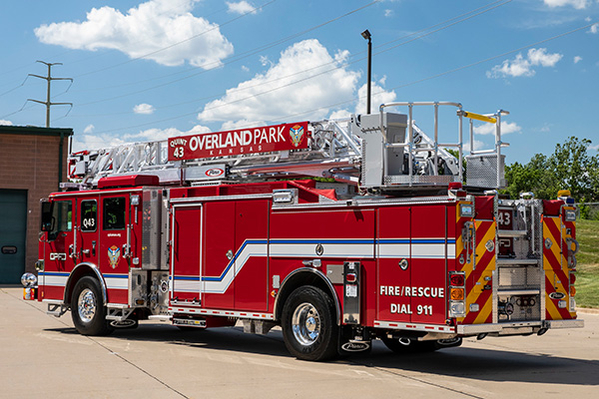 Aerial ladder fire truck drivers side parked in the sun 