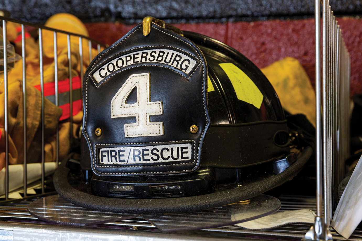 Fire department helmet sitting in fire locker