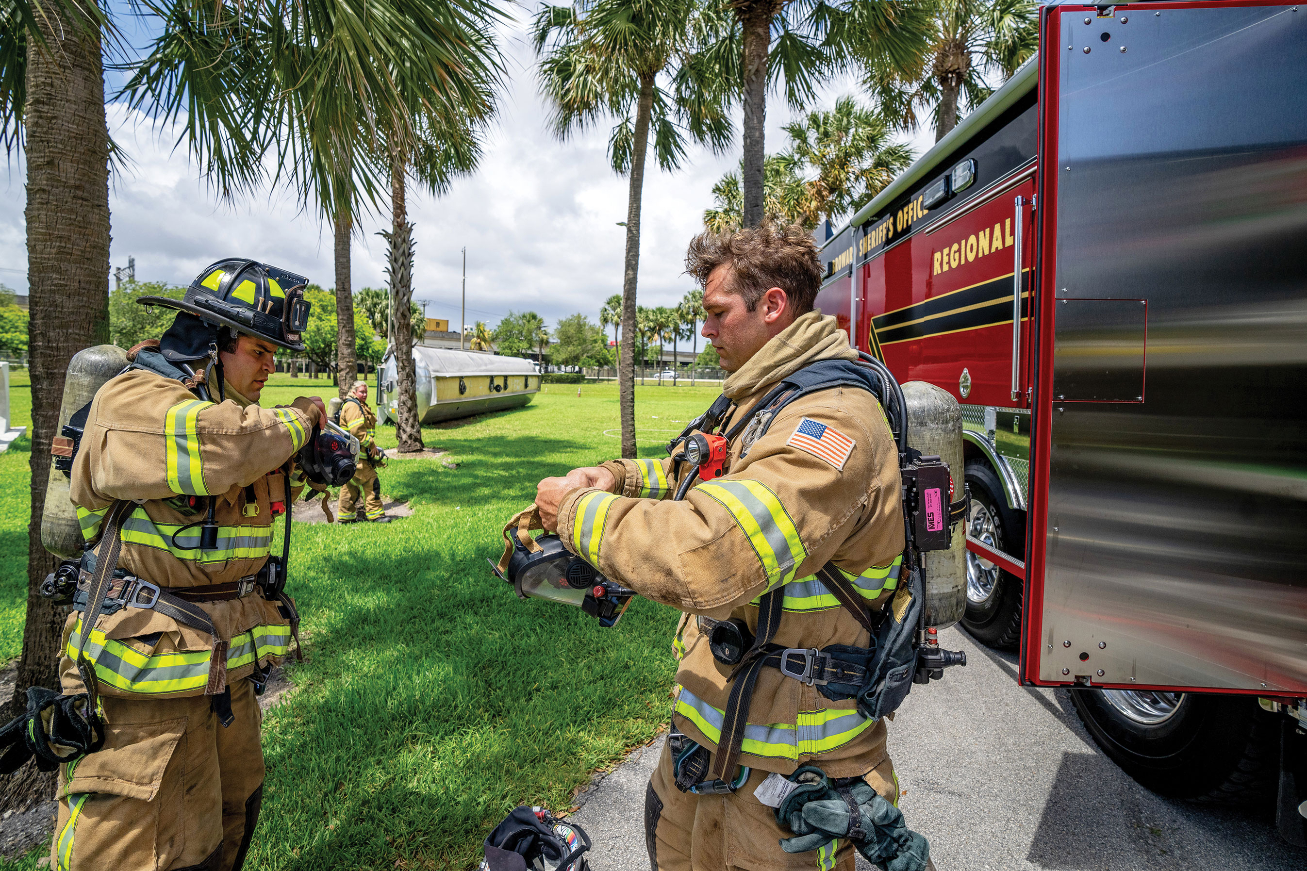 Two firefighters responding to call with their Heavy-Duty Rescue Fire Apparatus