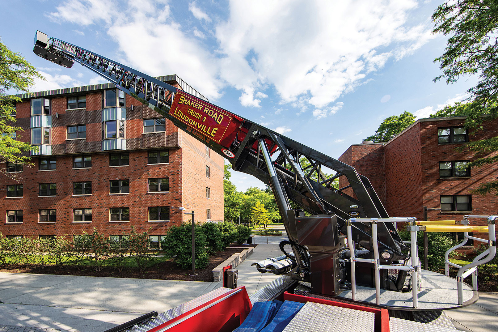 Aerial ladder fire truck extended over five story building