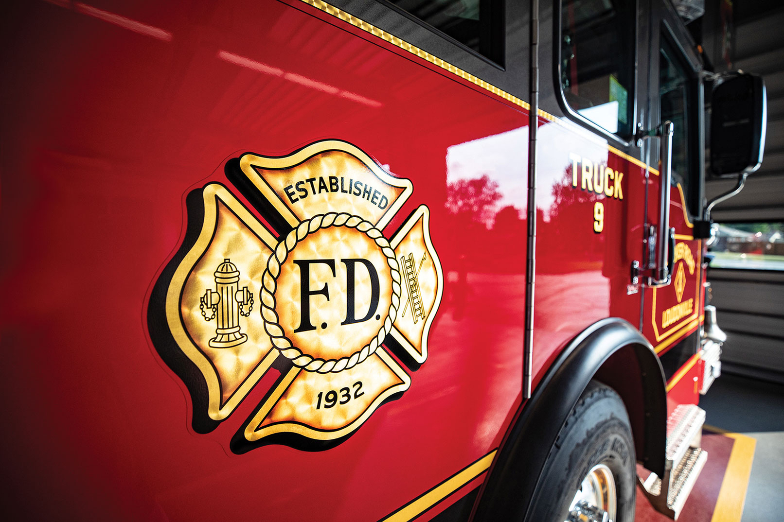 Officers side of aerial platform fire truck custom gold leaf logo for Loudounville New York