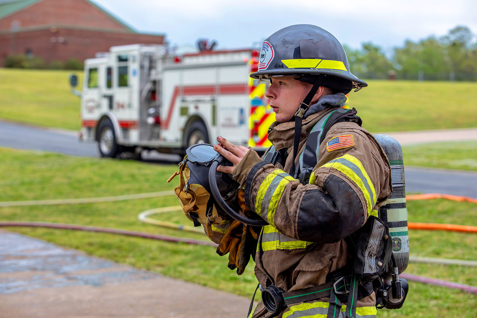 Tuscaloose Firefighter responding to call with pumper fire truck pumping